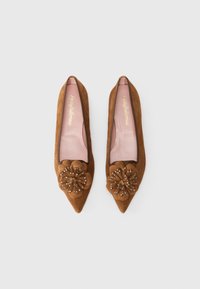 Brown suede pointed-toe flats featuring a floral embellishment with bead accents on the front and a soft pink insole.