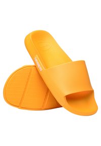 Infradito arancioni senza chiusura con una finitura liscia e opaca, suole testurizzate e forma contenuta. Presentano un motivo a spina di pesce sulla suola.