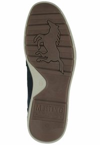 Suola in gomma marrone con logo a forma di cavallo, scanalature verticali e "MUSTANG True Denim" in rilievo. Il lato presenta una parte superiore in tessuto nero liscio.