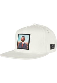 White snapback cap featuring a graphic patch of a suited figure with a basketball for a head, set against a blue and landscape background.