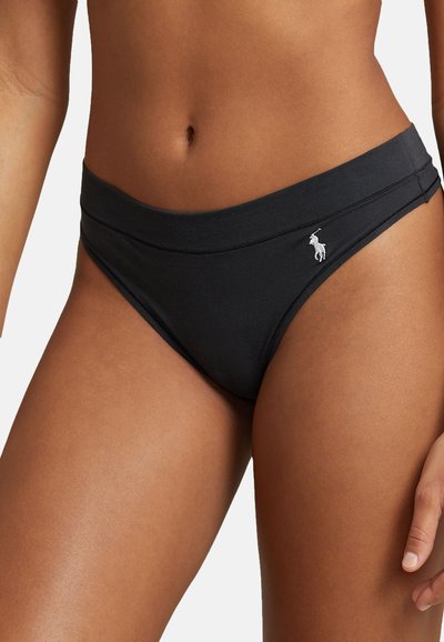 Black swim briefs with a smooth texture and a high waist design, featuring stitched detailing and a small white logo on the side.