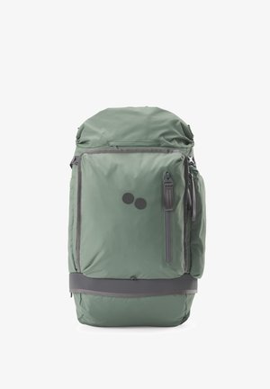 Sac à dos vert avec une grande poche avant, une fermeture éclair verticale, deux petits boutons ronds foncés et une bordure grise sur fond blanc.