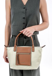 Borsa a mano beige e marrone con manico superiore, dotata di tasca frontale con zip e dettagli di cucitura. Realizzata in materiale sintetico liscio.