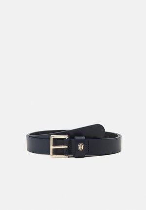 Black leather belt with a gold rectangular buckle and a small gold logo on the belt loop, laid flat on a white background.