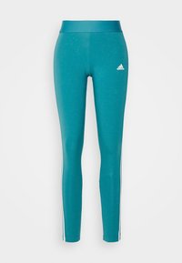 Teal leggings med en figurnära design, tillverkade av strechigt material. Har vita sidosträck och en liten vit logotyp på övre vänstra benet.