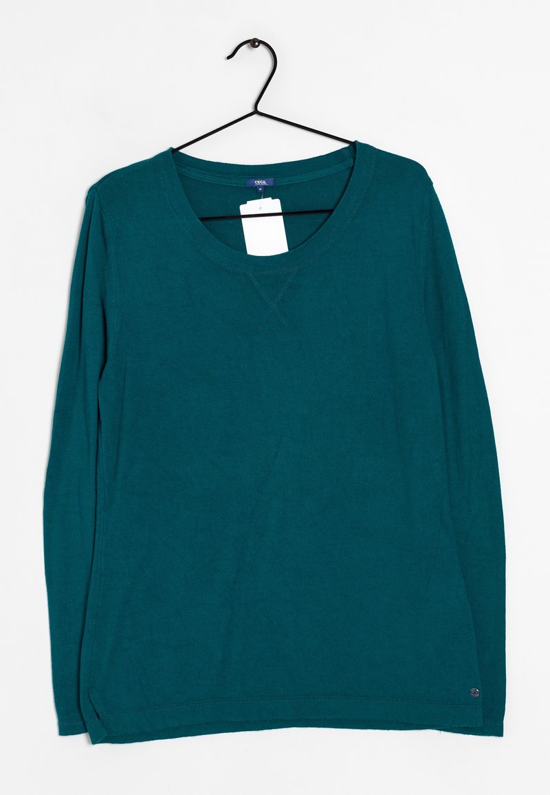 Maglietta a maniche lunghe di colore teal realizzata in tessuto morbido. Presenta un collo a barchetta e fessure laterali all'orlo. Etichetta attaccata.