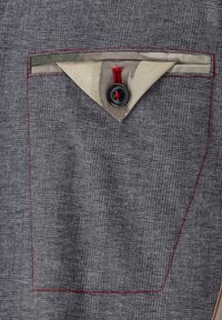 Gray fabric with subtle texture, featuring a triangular camouflage pocket, red stitching, and a black button with red thread accent.