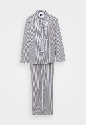 Striped two-piece outfit consisting of a jacket with toggle closures and matching trousers. Colors are primarily white and navy blue.