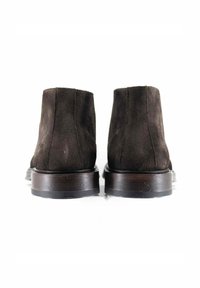 Stivaletti alla caviglia in suede marrone scuro con punta arrotondata e tacco in legno liscio e basso. Presentano un design semplice e lineare senza decorazioni visibili.