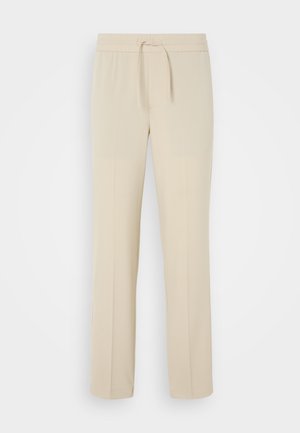 Beige, elasztikus derékpántú nadrág húzózsinórral. Egyenes szárú és sima tapintású, alkalmas hétköznapi viseletre vagy pihenésre.