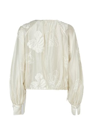 Blusa corta in tessuto crema con ricami floreali bianchi. Maniche lunghe e puffate con dettaglio a bottoni ai polsini. Collo arricciato.
