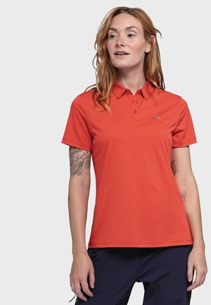 Red polo shirt with a collar, three-button placket, and subtle textured pattern. Features a small logo on the left chest.