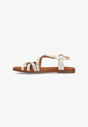Metallic silver strappy sandals with an open toe and heel, featuring a brown insole and flat rubber sole. Adjustable ankle strap detail.