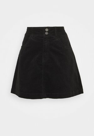 Jupe noire en velours côtelé forme trapèze avec deux poches frontales et fermeture double boutons métal à la taille.