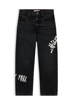 Fekete egyenes szárú farmer, fehér graffitis „New York” felirattal a bal lábszáron és „Hilfiger” felirattal a jobb lábszáron, ötlovas dizájn.
