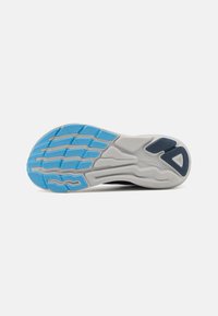 Shoe sole featuring a white base with textured gray rubber and blue traction patterns. Curved design for flexibility and grip.