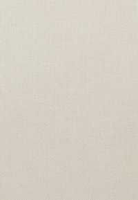 Tessuto ribbed di un beige chiaro con una superficie texture. Il materiale è morbido e presenta linee verticali equidistanti su tutta l'area.