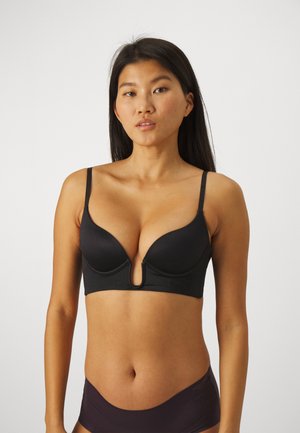 Black push-up bra featuring a plunging neckline, adjustable straps, smooth texture, and a front cut-out detail.