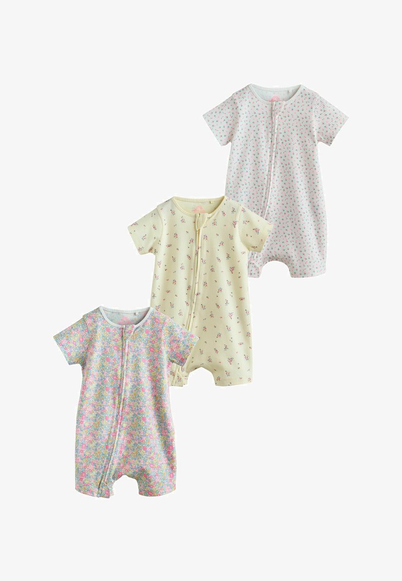 Trois grenouillères pour bébé à manches courtes avec fermetures éclair à l'avant, présentant de petits motifs floraux en blanc, jaune et multicolores.