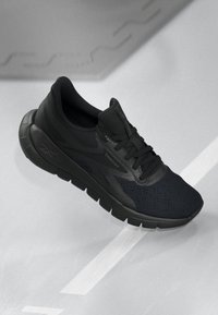 Black athletic shoe with a mesh upper, lace closure, and textured sole. Features subtle branding and a streamlined design.