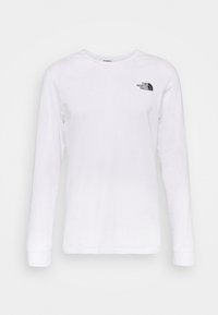 Vit långärmad skjorta i bomull med en liten svart logotyp på övre vänster sida, ribbade ärmmuddar och rundad halsringning.