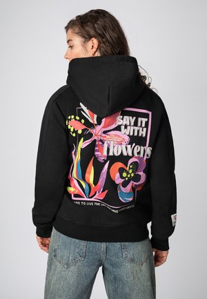 Schwarzer Kapuzenpullover mit lebendigen Blumenmotiven auf dem Rücken, einschließlich des Textes "SAY IT WITH flowers" in fetten, farbenfrohen Schriftarten.
