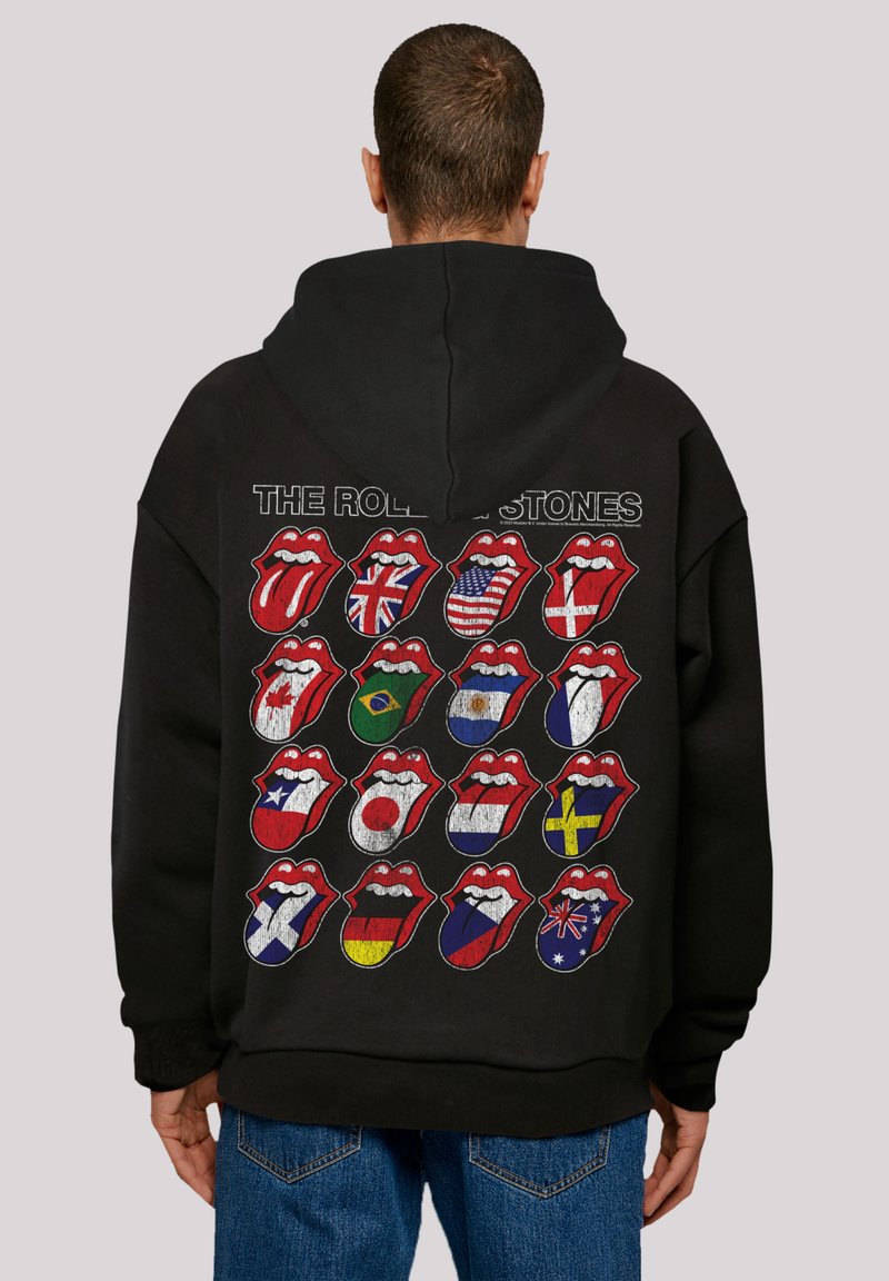 Black hoodie featuring the Rolling Stones' iconic lips logo, with multiple country flag designs in a grid pattern on the back.