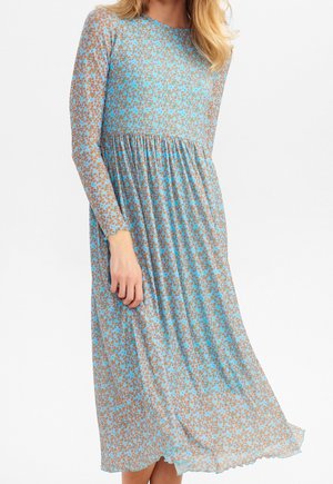 Pitkähihaista mekkoa, joka on valmistettu kevyestä kankaasta. Mekossa on sinivihreä ja ruskea kukkakuosi,Gathered vyötärö ja valuva helma.