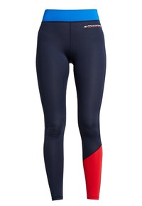 Granatowe legginsy z jasnoniebieskim pasem w talii i czerwoną częścią dolnej lewej nogawki, z małym logo Tommy Hilfiger w pobliżu talii.