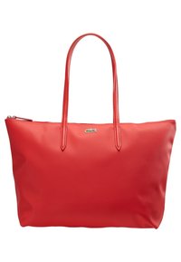 Sac cabas rectangulaire rouge avec double poignée, fermeture éclair et petit logo crocodile vert au centre devant.
