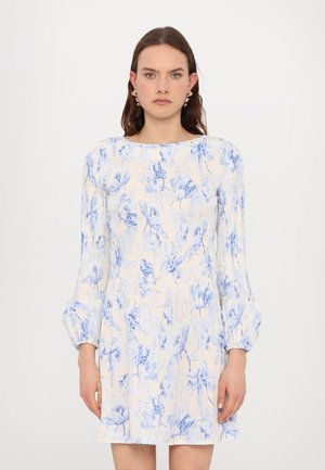 Cream dress with blue floral prints, long puff sleeves, and a round neckline. Light, textured fabric with a flared silhouette. No other details visible.