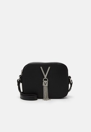 Black textured crossbody bag with silver hardware, featuring a chain tassel and a large "V" lock design on the front. Adjustable strap included.