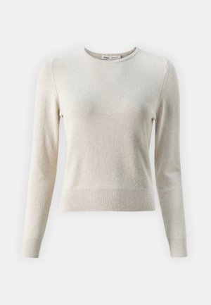 Világos bézs hosszú ujjú pulóver, puha anyagból készült. Kerek nyakkivágással, bordázott mandzsettákkal és testhezálló fazonnal rendelkezik.