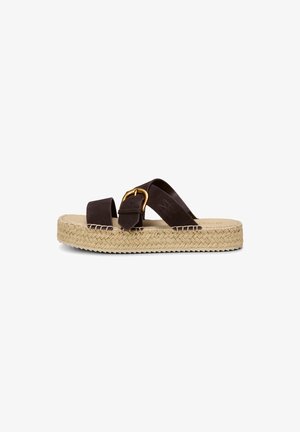 Espadrille-style sandal with woven jute platform sole, two dark brown straps, and a large gold buckle on one strap.