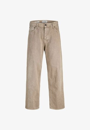 Czarna bawełniana koszulka z małym białym nadrukiem "ORIGINALS Studio". Połączona z jasnobeżowymi spodniami o szerokich nogawkach i białymi trampkami.