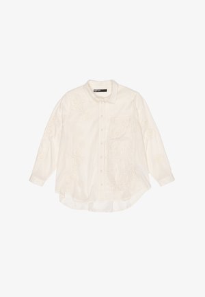 Biała, długa koszula z długim rękawem, zdobiona haftowanymi kwiatowymi wzorami, z kieszonką na piersi i frędzlami na kieszeni. Miękka, teksturowana tkanina.