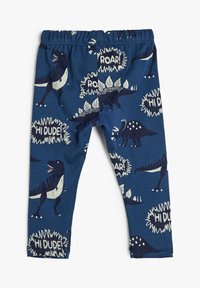 Navyblauwe leggings van zacht stof, met een dinosauruspatroon en spraakballonnen met de teksten "HI DUDE!" en "ROAR!" in crèmekleurige accenten.