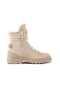 Bottines en simili cuir beige avec un bord en fausse fourrure, devant à lacets, fermeture à glissière sur le côté et semelle épaisse. Accents en doré inclus.