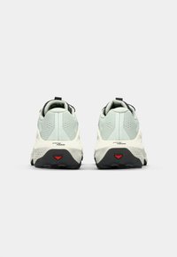 Light blue athletic shoes with a textured fabric upper, black accents, a padded collar, and a thick white sole featuring a red detail on the heel.