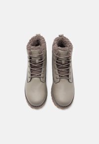 Grey leather ankle boots with a soft, textured brown faux fur lining, lace-up front, and a rugged rubber sole.