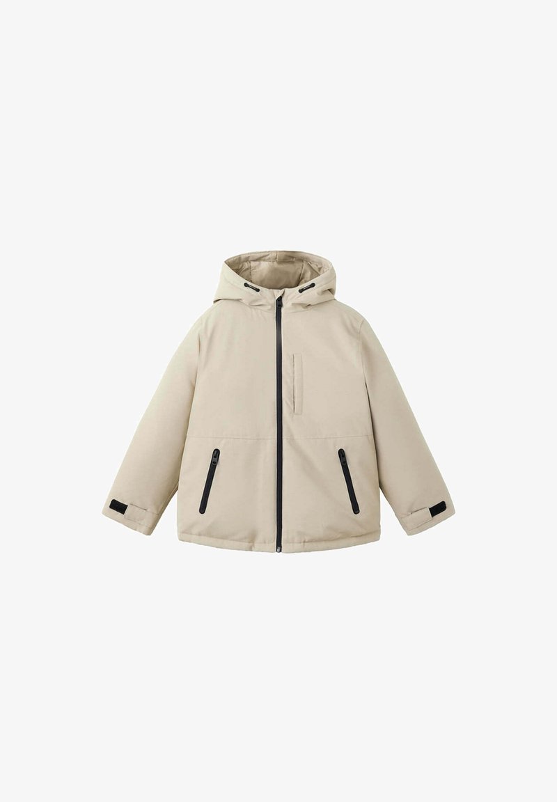 Veste beige à capuche avec fermeture éclair à l'avant, deux poches latérales zippées, une poche poitrine et des bracelets ajustables aux poignets.