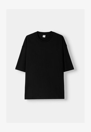 Black cotton t-shirt with short sleeves, round neck, and a relaxed fit. Smooth texture and minimalistic design, no patterns or accents.