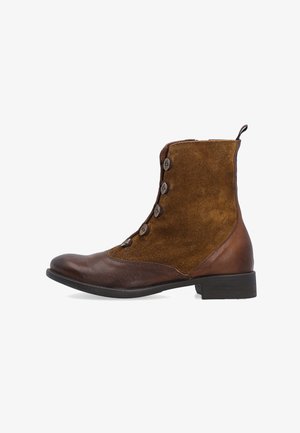 Braune Leder- und Wildleder-Stiefelette mit fünf Knöpfen, glattem Vorderfuß, strukturiertem Obermaterial und niedrigem Absatz. Verstellbare Schlaufe auf der Rückseite.