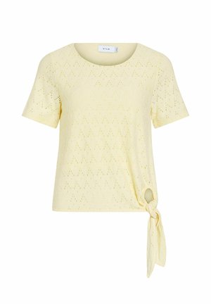 Haut jaune clair à manches courtes avec motif ajouré et détail de nœud sur le côté à l’ourlet, encolure ronde.