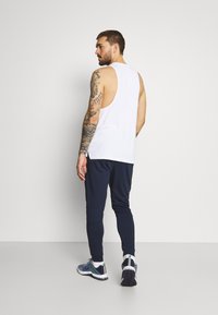 Nike Performance TAPER - Trainingsbroek - obsidian/white