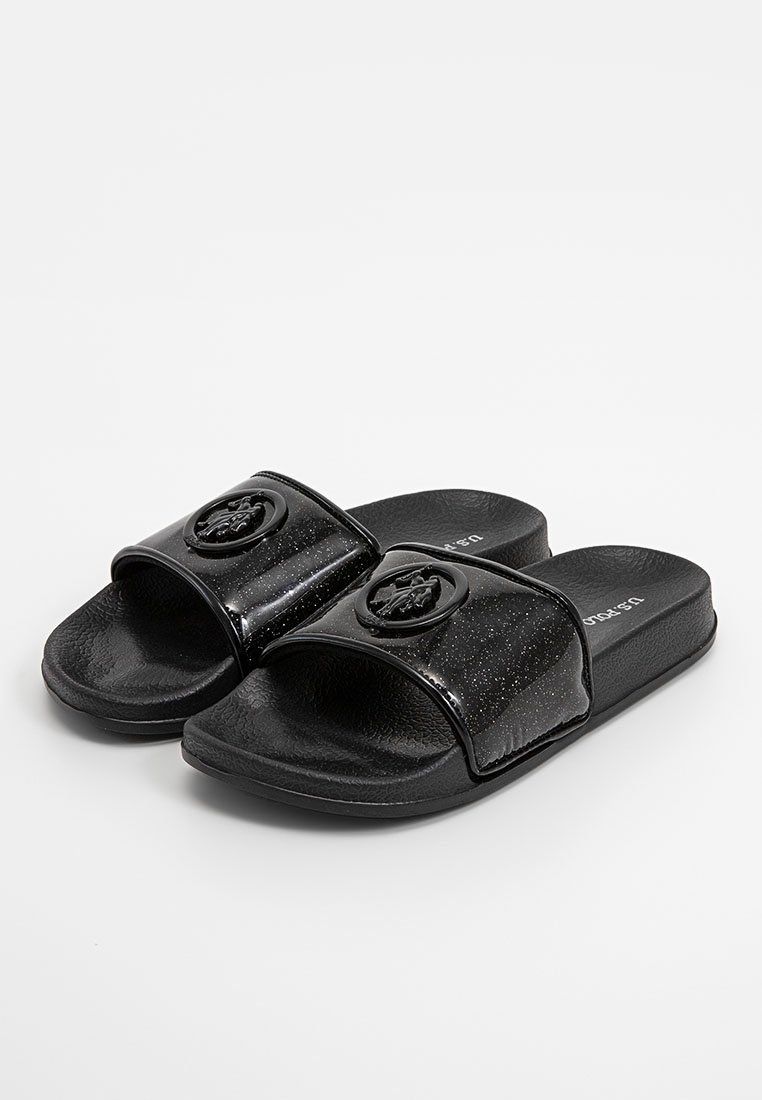 Zwarte slide sandalen van glanzend materiaal met een gestructureerde zool, voorzien van een rond logo-embleem en een gespikkeld ontwerp op de band.