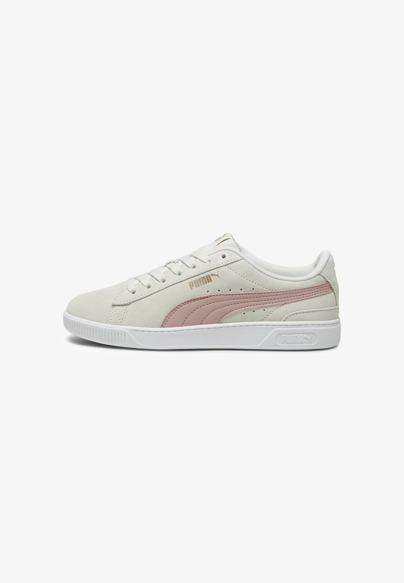 Puma-Sneaker aus leicht beigem Wildleder mit einem pinken Lederakzent und weißer Gummisohle; ausgestattet mit Perforationen und Schnürdesign.