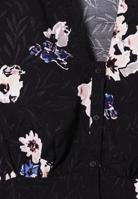 Black fabric dress with floral pattern in pink, white, and blue. Features button front and embroidered leaf details, creating a textured appearance.