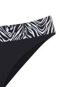 Schwarze Bikiniunterhose mit einem einfarbigen schwarzen Grund und einem weißen Zebra-Streifenbund. Hergestellt aus elastischem Material, das für Komfort sorgt.