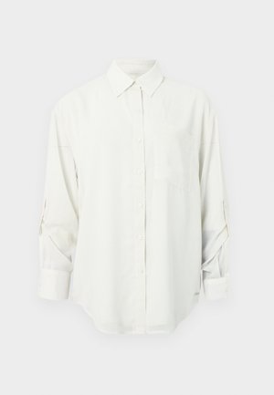 White long-sleeve button-up shirt with a collar, single chest pocket, and rolled-up sleeves. Soft, smooth fabric and relaxed fit.